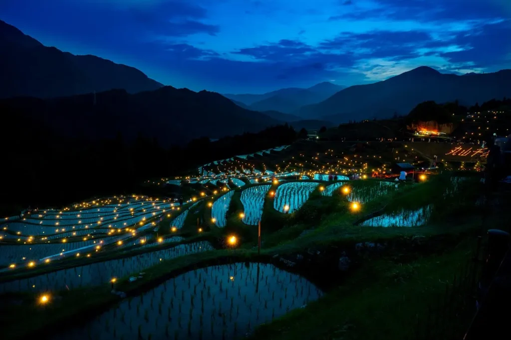 Night view of illuminated rice terraces in rural Japan