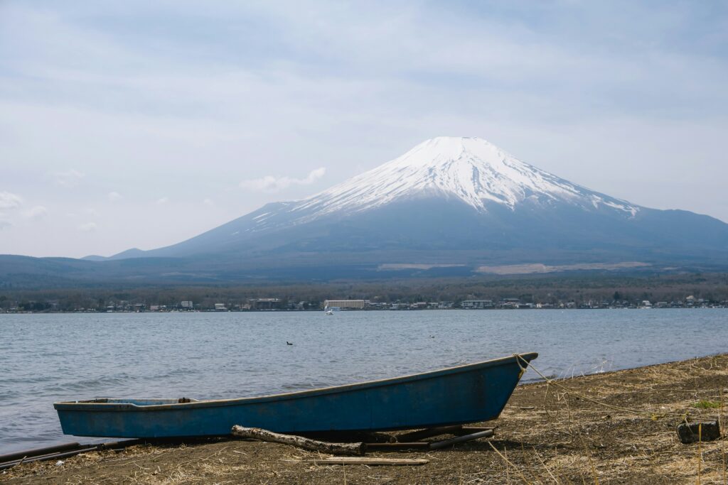 Blue boat on Lake Yamanaka with Mount Fuji in the background