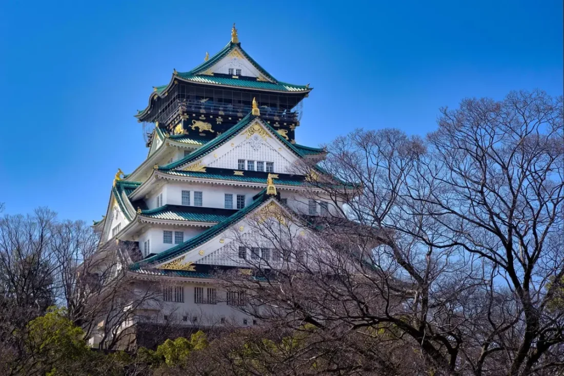 Osaka Castle with green roofs and blue sky