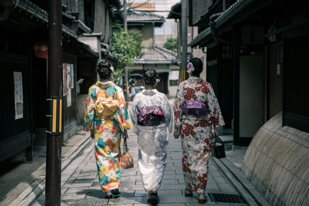 Kyoto’s preserved neighborhoods where visitors often rent kimono to explore charming wooden alleyways and traditional teahouse districts.